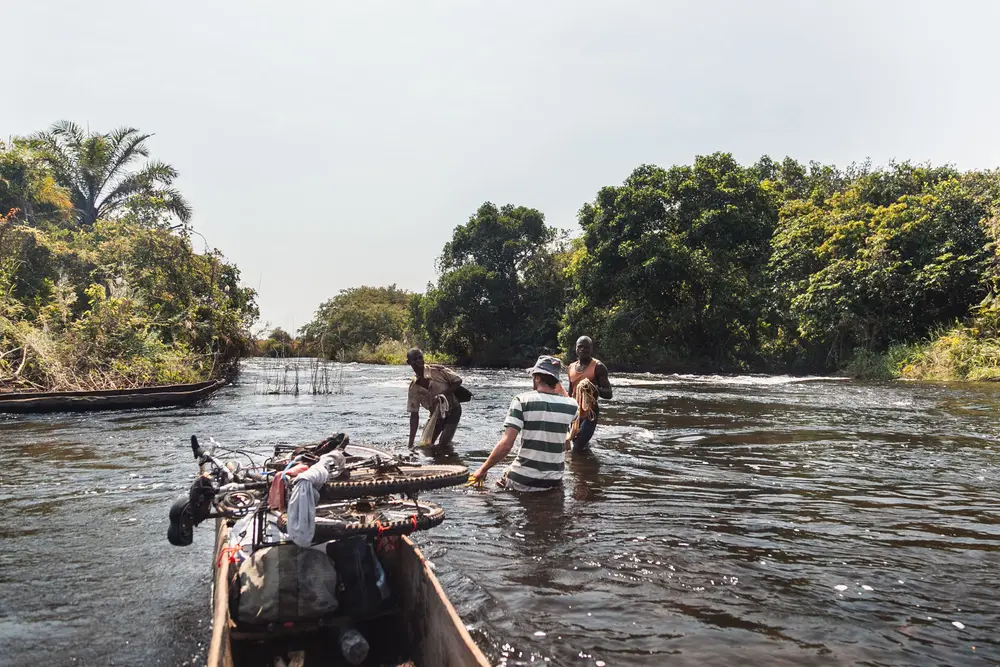 Charlie discusses with fishermen which side of the river we should take to avoid the worst of the rapids.