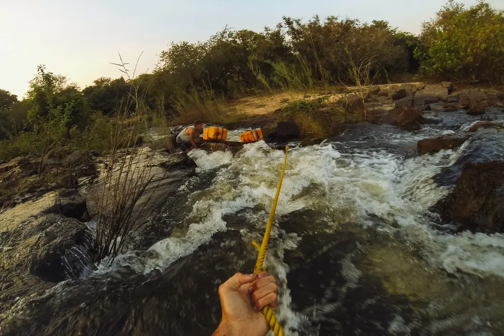Charlie acts as anchor whilst I guide the the pirogue through a narrow set of offshoot rapids.
