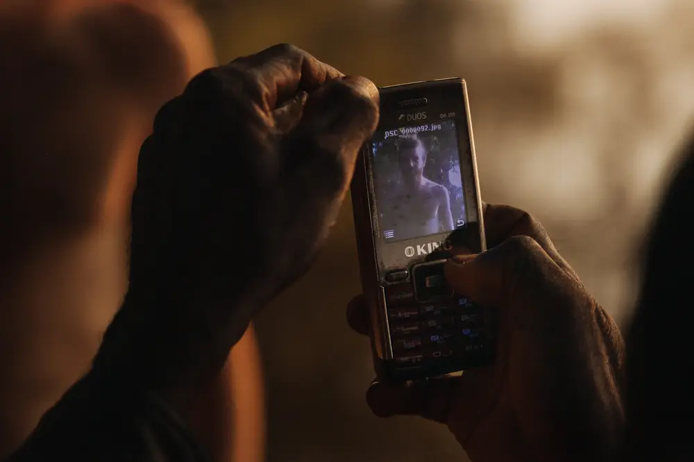A fisherman takes a photo of Charlie.
