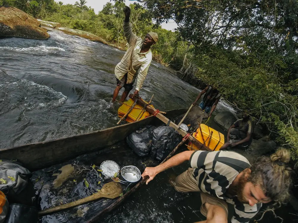 Getting some local assistance tackling the next set of rapids. Our several leaks necessitated hourly bailing sessions in order to keep us afloat and our gear dry.