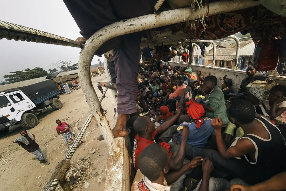 Every space is occupied. The next 24 hours sees fighting break out, men and woman being sick and kids urinating, all within the back of the truck.